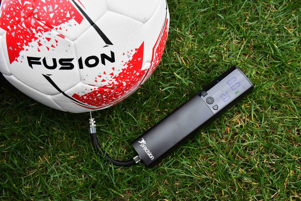 Precision electric ball pump inflating a football